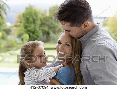 Picture - Family smiling together outdoors. Fotosearch