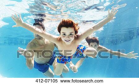 Stock Photography - Family swimming in pool. Fotosearch
