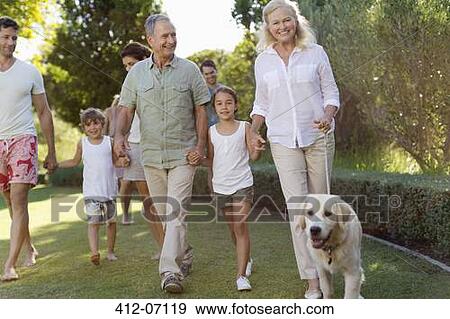 Stock Photo - Family walking together in park. Fotosearch