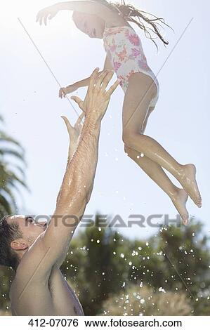 Father and daughter playing in swimming pool View Large Photo Image Stock Photograph - Father and daughter playing in swimming pool. Fotosearch