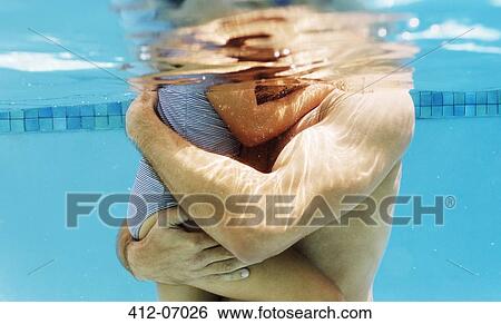 Stock Photograph - Father holding daughter in swimming pool. Fotosearch
