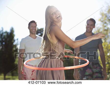 Girl hula hooping outdoors View Large Photo Image Stock Image - Girl hula hooping outdoors. Fotosearch