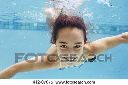 Stock Photography - Girl swimming in pool. Fotosearch