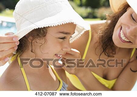 Stock Photo - Mother and daughter wearing sunhats. Fotosearch