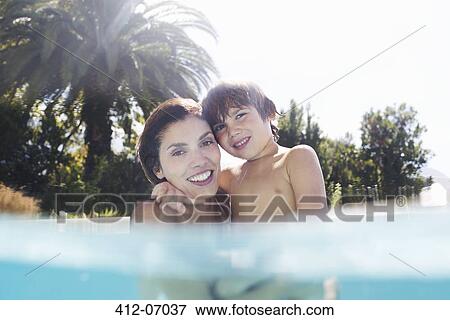 Mother holding son in swimming pool View Large Photo Image Stock Photo - Mother holding son in swimming pool. Fotosearch