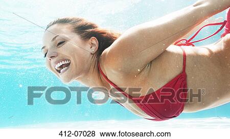 Woman swimming in pool View Large Photo Image Stock Photo - Woman swimming in pool. Fotosearch