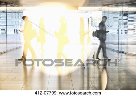 Stock Photo - Business people walking in lobby. Fotosearch
