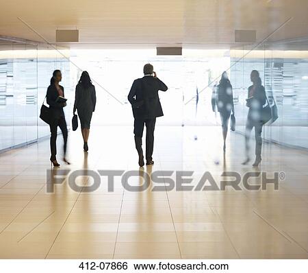 Business people walking in lobby View Large Photo Image Stock Photograph - Business people walking in lobby. Fotosearch