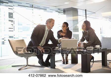 Business people with laptop meeting in lobby View Large Photo Image Stock Image - Business people with laptop meeting in lobby. Fotosearch