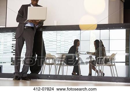 Picture - Business people working in lobby. Fotosearch