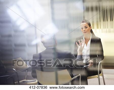 Businessman and businesswoman talking in office View Large Photo Image Stock Photograph - Businessman and businesswoman talking in office. Fotosearch