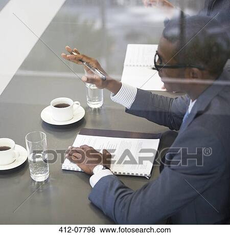 Businessman gesturing in meeting View Large Photo Image Stock Photo - Businessman gesturing in meeting. Fotosearch