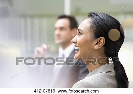 Businesswoman laughing in meeting View Large Photo Image Stock Photo - Businesswoman laughing in meeting. Fotosearch