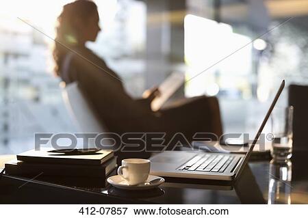 Businesswoman using digital tablet in lobby View Large Photo Image Stock Photo - Businesswoman using digital tablet in lobby. Fotosearch