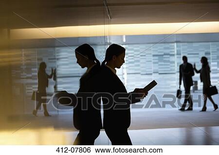 Businesswoman using digital tablet in lobby View Large Photo Image Stock Photograph - Businesswoman using digital tablet in lobby. Fotosearch