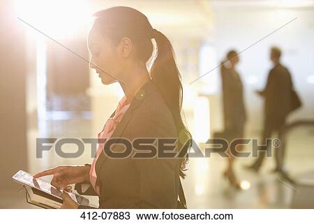 Businesswoman using digital tablet View Large Photo Image Stock Image - Businesswoman using digital tablet. Fotosearch