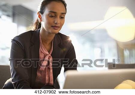 Stock Image - Businesswoman using laptop. Fotosearch