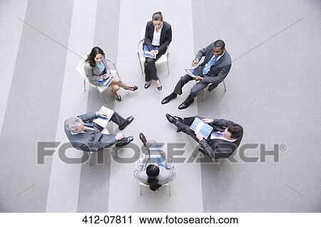 High angle view of business people sitting in circle View Large Photo Image Stock Image - High angle view of business people sitting in circle. Fotosearch