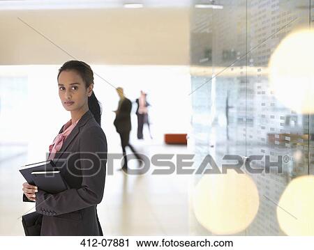 Portrait of confident businesswoman in lobby View Large Photo Image Stock Image - Portrait of confident businesswoman in lobby. Fotosearch