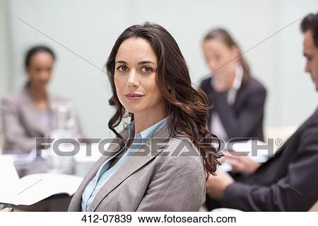 Portrait of confident businesswoman in meeting View Large Photo Image Stock Photo - Portrait of confident businesswoman in meeting. Fotosearch