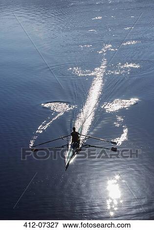Stock Photo - Man rowing on lake. Fotosearch
