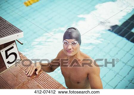 Portrait of swimmer standing at the edge of pool View Large Photo Image Stock Image - Portrait of swimmer standing at the edge of pool. Fotosearch