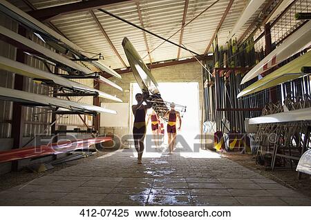 Rowing crew carrying scull into shed View Large Photo Image Stock Photography - Rowing crew carrying scull into shed. Fotosearch
