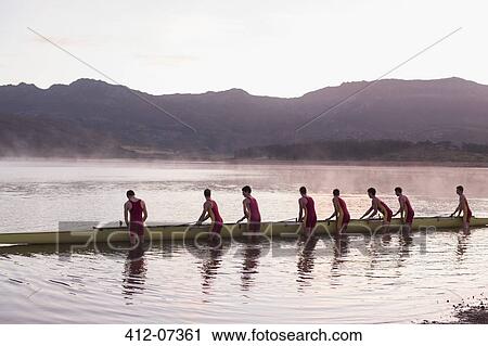 Rowing crew placing scull in lake at dawn View Large Photo Image Stock Image - Rowing crew placing scull in lake at dawn. Fotosearch