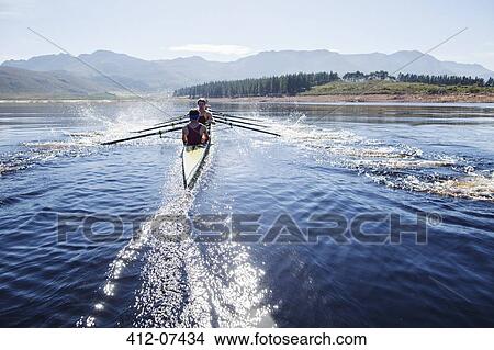 Rowing crew rowing scull on lake View Large Photo Image Picture - Rowing crew rowing scull on lake. Fotosearch