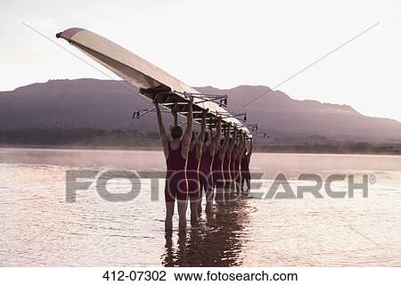 Rowing team carrying row boat overhead in still lake View Large Photo Image Stock Image - Rowing team carrying row boat overhead in still lake. Fotosearch