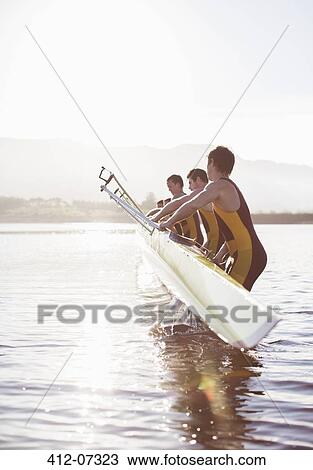 Rowing team placing boat in lake View Large Photo Image Stock Image - Rowing team placing boat in lake. Fotosearch