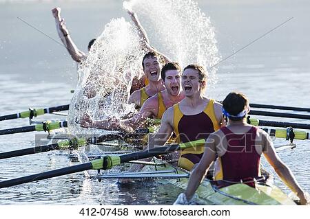Rowing team splashing and celebrating in scull on lake View Large Photo Image Stock Photo - Rowing team splashing and celebrating in scull on lake. Fotosearch