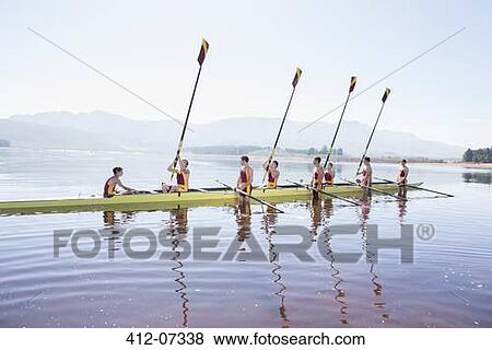 Rowing team with oars raised on lake View Large Photo Image Stock Photo - Rowing team with oars raised on lake. Fotosearch