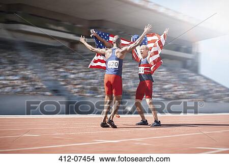 Runners celebrating and holding American flags on track View Large Photo Image Picture - Runners celebrating and holding American flags on track. Fotosearch
