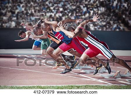 Stock Photo - Runners taking off from starting blocks on track. Fotosearch