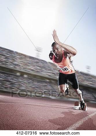 Stock Photograph - Sprinter taking off from starting block. Fotosearch
