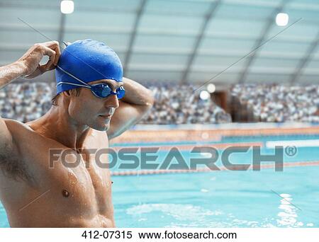 Stock Photography - Swimmer adjusting goggles at pool. Fotosearch