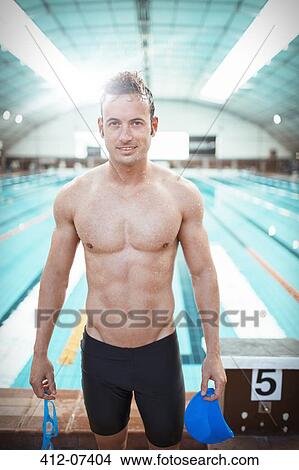 Swimmer standing at poolside View Large Photo Image Picture - Swimmer standing at poolside. Fotosearch