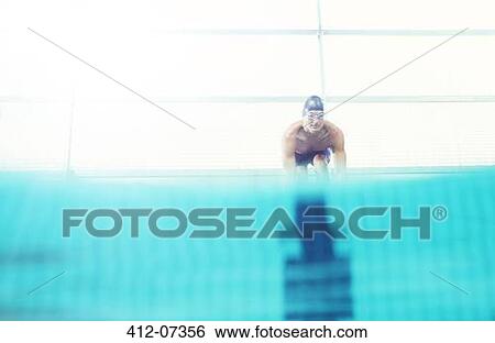 Swimmers poised on starting blocks View Large Photo Image Stock Photograph - Swimmers poised on starting blocks. Fotosearch