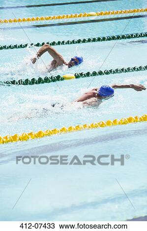 Swimmers racing in pool View Large Photo Image Stock Image - Swimmers racing in pool. Fotosearch