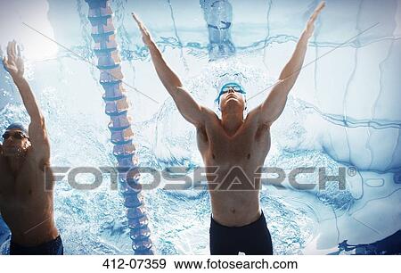 Stock Photo - Swimmers racing in pool. Fotosearch