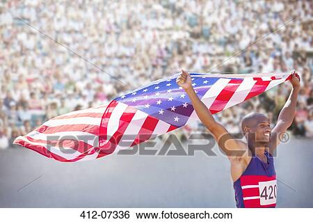 Track and field athlete holding American flag in stadium View Large Photo Image Stock Photograph - Track and field athlete holding American flag in stadium. Fotosearch