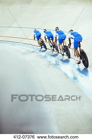 Stock Photograph - Track cycling team riding in velodrome. Fotosearch