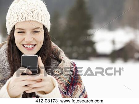 Close up of woman in knit hat text messaging with cell phone View Large Photo Image Stock Image - Close up of woman in knit hat text messaging with cell phone. Fotosearch