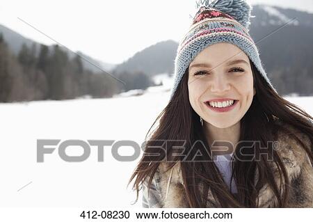 Close up portrait of happy woman wearing knit hat in snowy field View Large Photo Image Stock Image - Close up portrait of happy woman wearing knit hat in snowy field. Fotosearch