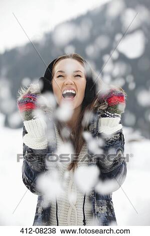 Enthusiastic woman enjoying falling snow View Large Photo Image Stock Photo - Enthusiastic woman enjoying falling snow. Fotosearch
