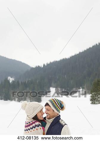 Stock Photography - Happy couple face to face in snowy field. Fotosearch