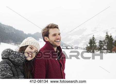 Picture - Happy couple in snowy field. Fotosearch