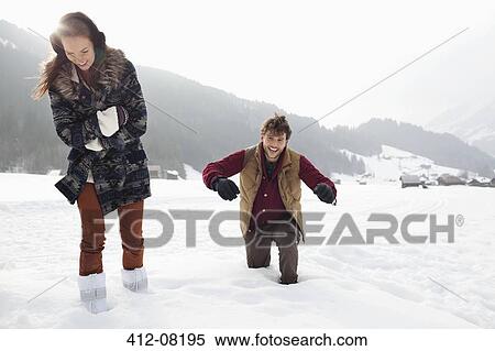 Happy couple walking through deep snow in field View Large Photo Image Stock Photography - Happy couple walking through deep snow in field. Fotosearch