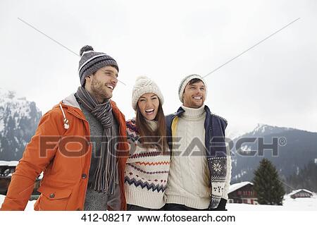 Happy friends in snowy field View Large Photo Image Stock Photo - Happy friends in snowy field. Fotosearch